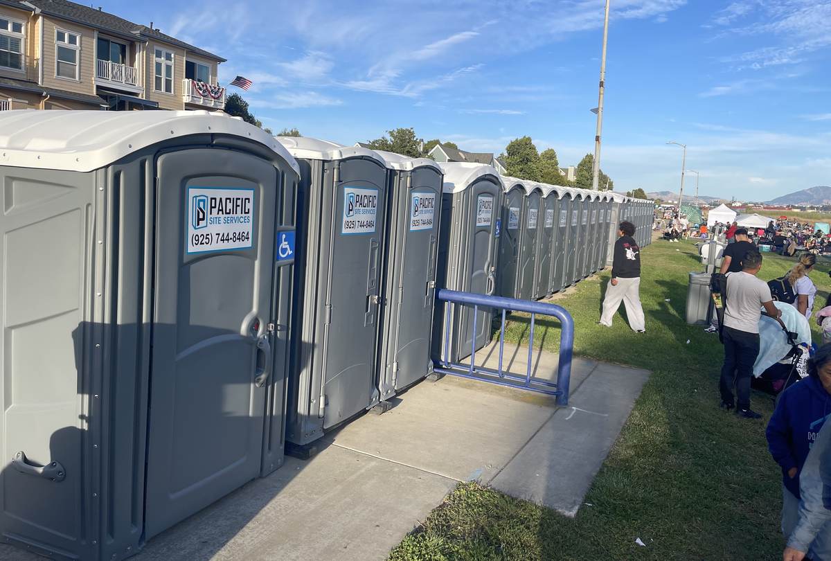 Pacific Site Services restroom bank including ADA units set along a paved path at a Bay Area community event